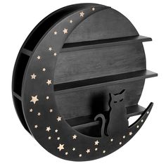 a wooden shelf with a cat sitting on it's side and stars around the top