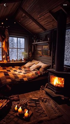 a bed sitting in front of a window next to a fire place with candles on it