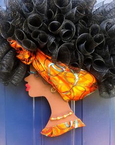 a woman's head is adorned with black hair and an orange dress on the front door