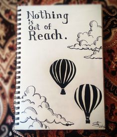 an open notebook with the words nothing is out of reach written in black and white