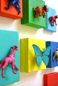 colorful wooden pegs are mounted to the wall with animals on them and text overlay