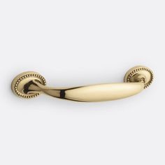 an antique brass door handle on a white background