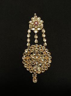 an ornate gold necklace with pearls and stones