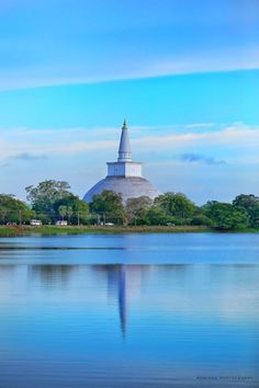 a large body of water with a tower in the background