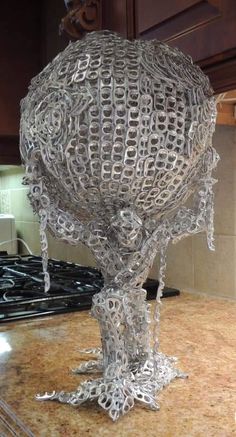 a large metal object sitting on top of a kitchen counter next to a stovetop