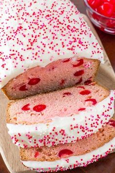 two slices of cake with white frosting and red sprinkles