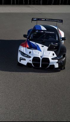 a white and blue race car driving on a track