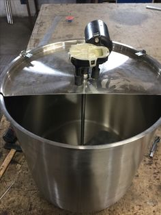 a large metal bowl sitting on top of a table