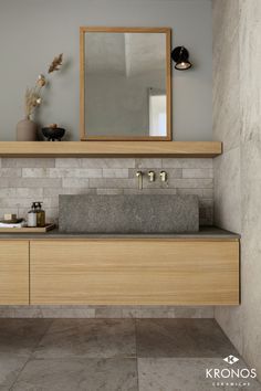 a bathroom with a sink, mirror and tiled walls in the background is an empty room