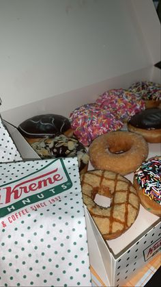 a box filled with lots of different types of doughnuts and sprinkles