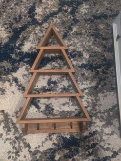 a wooden shelf sitting on top of a carpeted floor