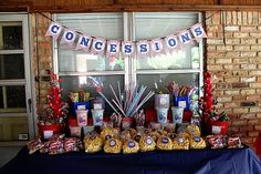 a table topped with candy and candies next to a brick wall in front of a window