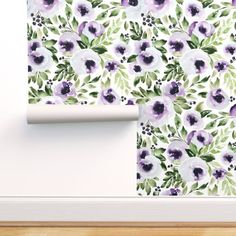 an image of wallpaper with purple flowers on the wall and green leaves in the background