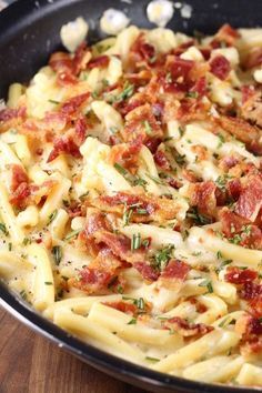 a pan filled with pasta covered in bacon and cheese