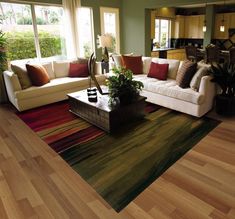 a living room filled with lots of furniture and decor on top of a wooden floor