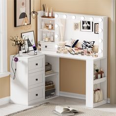 a white vanity with lights on it in a room next to a mirror and pictures