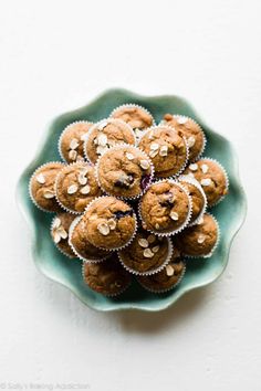 a green plate filled with chocolate chip muffins on top of a white table