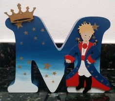 the letter m is made out of wood and has a king figure