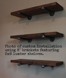 three wooden shelves mounted to the side of a wall with metal brackets on each shelf