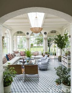 a living room filled with furniture and lots of windows