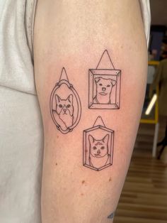 a person with a tattoo on their arm has a dog and cat in a frame