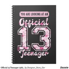 a spiral notebook with the number thirteen printed in pink and white on it, which reads you are looking at an official 13 teenager