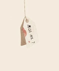 a tag hanging from a string with the words miss me