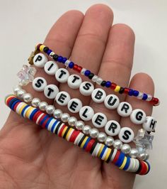 🏈 Show your support for your favorite team with this stack of handmade beaded bracelets! The Steelers stack comes with 4-- two seed bead, one clay heishi bead, and one pearlescent beaded bracelet-- or 5 bracelets (add a simple seed bead bracelet).  Handmade with love and care and shipped from central Texas 💛🖤 Steelers Clay Bead Bracelet, Football Team Clay Bead Bracelets, Football Bracelet Stack, Nfl Clay Bead Bracelets, Steelers Beaded Earrings, Football Bracelet, Heishi Beads, Bracelets Handmade Beaded, Seed Bead Bracelets