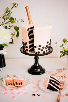 there is a cake on the table and some cookies are next to it with a champagne bottle