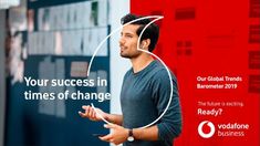 a man standing in front of a red and white sign that says your success is times of change