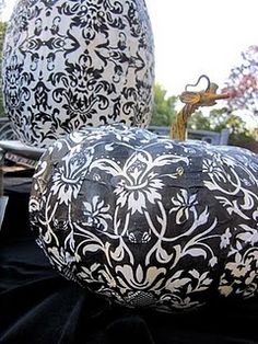 two large black and white vases sitting on top of a table