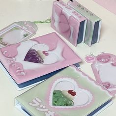 some pink and green items on a white table with other items in the shape of hearts