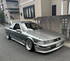 a silver car parked in front of a house