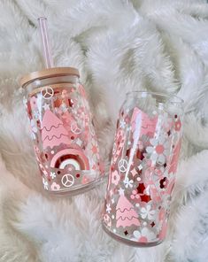 two pink and silver cups sitting on top of a white furnishing covered floor