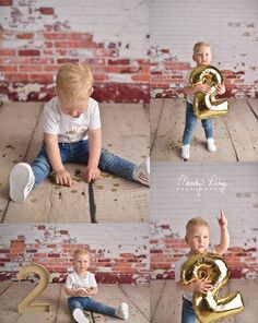 a little boy sitting on the floor holding a gold number 2 balloon in his hands