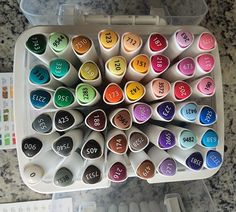 a box filled with lots of different colored markers