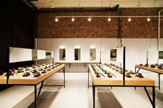 a room filled with lots of wooden tables covered in different types of jewelry on display