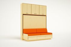 an orange couch sitting in front of a wooden cabinet with doors on the back side