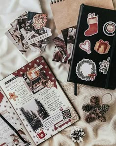 an open notebook sitting on top of a bed next to christmas decorations and other items