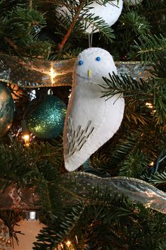 an owl ornament hanging from a christmas tree