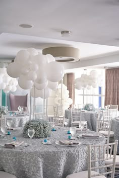 the tables are set with white balloons and place settings