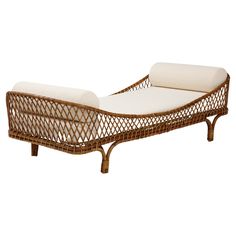 a brown wicker chaise lounger with white cushions on an isolated white background