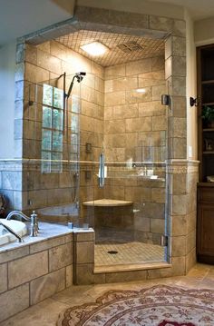 a bathroom with a walk in shower next to a bathtub and rug on the floor