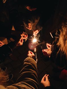 several people are holding sparklers in their hands