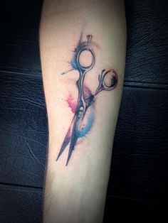 a tattoo on the arm of a person with scissors