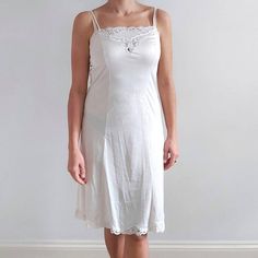 This is a neat, fitted vintage slip dress in off-white. It has spaghetti straps, chest lace details and a lace trimmed hemline. The slip is made from smooth, lightweight and silky to touch fabric. Perfect for wearing underneath the dress or as a nightie. Made by St. Michael in United Kingdom. 100% nylon/ poliamide mix. Labelled as size 14 UK long, 42 EUR, would fit Medium size. Measurements when laid flat are: Bust: 42cm Waist: 39cm Hips: 50cm Length: 103cm Excellent condition. B+E Dark Floral Dress, Vintage Slip Dress, Womens Lingerie, Vintage Slip, Midi Slip Dress, Lace Slip Dress, 80s Dress, White Slip, Silk Slip Dress