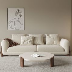 a living room with a white couch and coffee table in front of a painting on the wall