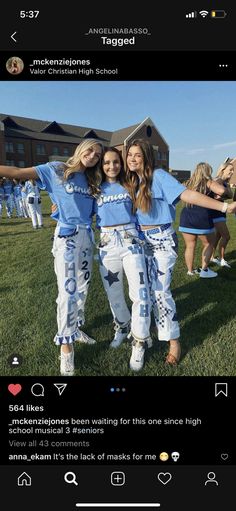 two girls in blue shirts and white pants posing for the camera with their arms around each other