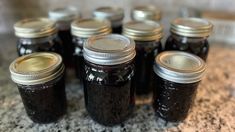 several jars filled with jam sitting on top of a counter