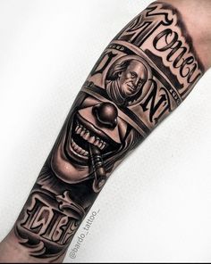 a man's arm with an evil clown tattoo on it